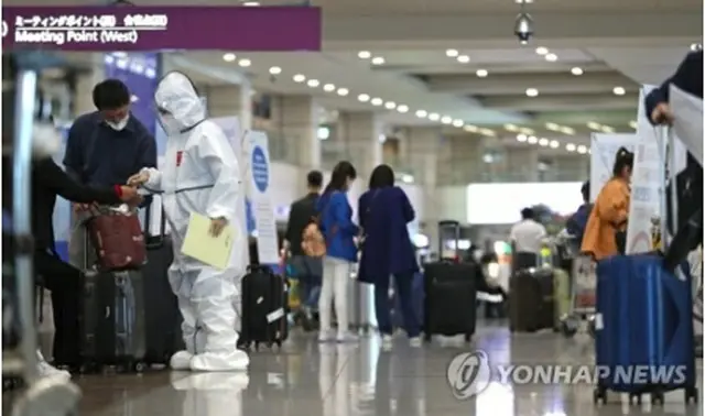 仁川国際空港で入国者を案内する防疫関係者＝（聯合ニュース）