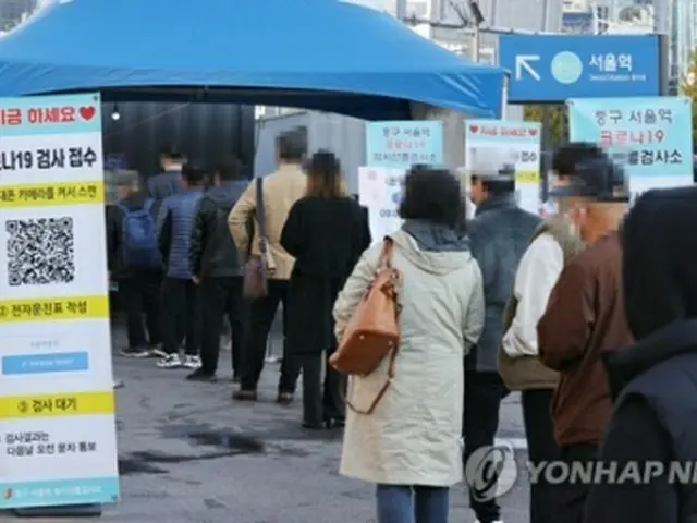 ソウル駅広場に設置された新型コロナウイルスの臨時検査所で順番を待つ人たち＝２８日、ソウル（聯合ニュース）