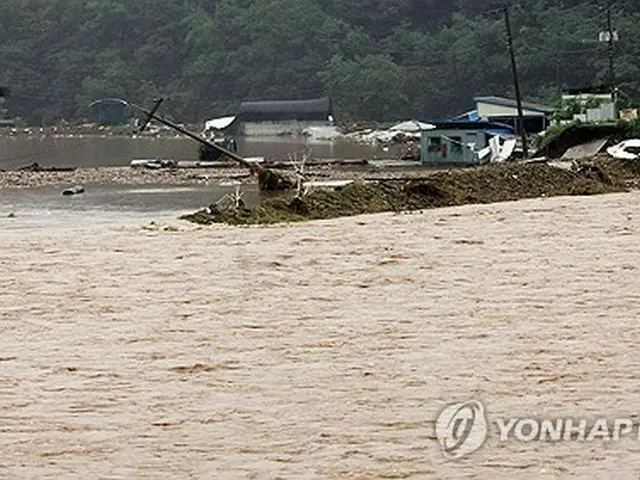 韓国南西部の完州郡で、大雨により河川に水が流れ込んでいる＝１０日、完州（聯合ニュース）