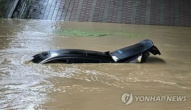 京畿道華城市で１８日、冠水した道路で車が水没している（華城市自律防災団提供）＝（聯合ニュース）≪転載・転用禁止≫