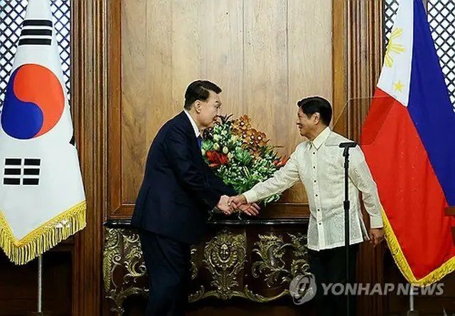 ７日にフィリピン・マニラで開かれた首脳会談で握手を交わす韓国の尹錫悦大統領（左）とフィリピンのマルコス大統領＝（聯合ニュース）